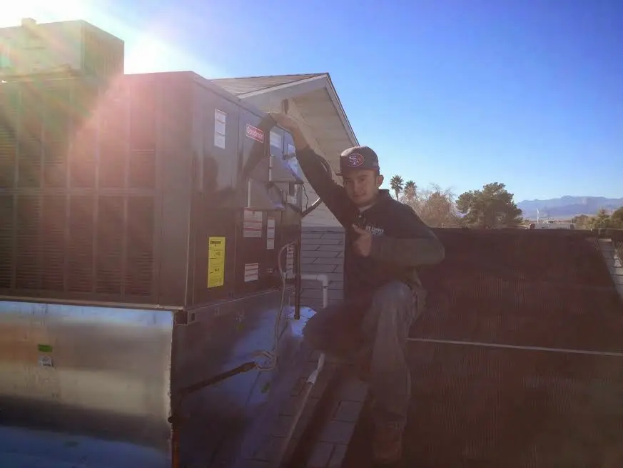 HVAC technician performing Boiler Repair on a rooftop unit in McKinney